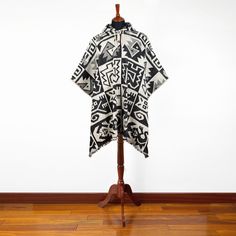 This unisex poncho features a substantial llama wool yarn fabric, making it a part of our collection of heavier wool ponchos. The fabric has been brushed to enhance comfort, making it a cozy addition to your wardrobe. Moreover, it showcases a black and white Aztec-inspired geometric animal motif, further elevating its already remarkable aesthetic.One Size fits all approx.: 49 W x 38 H inch / 125 cm W x 97 cm H incl. fringeThis poncho is designed to fit sizes ranging from Medium to 3XLMaterial: L Black Alpaca Poncho For Winter, Black Alpaca Cape For Winter, Black Alpaca Shawl For Winter, Black Alpaca Shawl Poncho, Wool Poncho, Hooded Poncho, Geometric Animals, Colour Pattern, Fabric Making