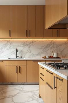 a kitchen with marble counter tops and wooden cabinets, along with a stove top oven