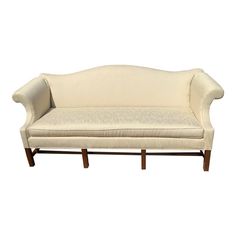 a white couch sitting on top of a wooden frame