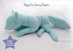 a blue stuffed animal laying on top of a white sheet with the words happy for sewing pattern