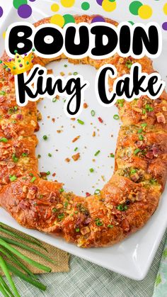 a cake with the words boudin king cake on it, surrounded by green beans