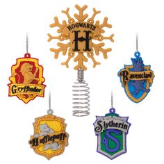 the hogwarts crest ornaments are hanging from hooks and hang on clothes pegs