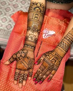 two hands with henna designs on them