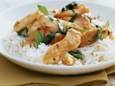 a white plate topped with rice and chicken