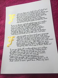 the letter f is written in cursive writing on white paper with yellow lettering