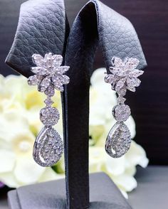 HANDCRAFTED TO PERFECTION! SPECIAL AND LOVELY FLORAL DESIGN, ILLUSION SETTING (APPEARS TO BE LIKE A 0.5 CARAT BRILLIANT PEAR Diamonds). With over 128 pieces of UNTREATED AND GENUINE F/VS QUALITY SPARKLING DIAMONDS! Perfect for every event! SET IN 18K SOLID WHITE GOLD HANDCRAFTED, DANGLING EARRINGS! SUGGESTED RETAIL VALUE: $8,800 DIAMONDS: 128 ROUND BRILLIANT, FULL CUT with excellent firing diamonds, weighting at 2.16 carats. ALL NATURAL, UNTREATED DIAMONDS. ALL DIAMONDS HAVE NO VISIBLE INCLUSION Party Drop Earrings With Brilliant Cut, Dazzling White Chandelier Earrings With Diamond Accents, Brilliant Cut Bridal Drop Earrings For Party, Brilliant Cut Drop Bridal Earrings For Party, Exquisite White Bridal Earrings Brilliant Cut, Dazzling White Diamond Earrings With Elegant Design, Dazzling White Diamond Dangle Earrings, Dazzling White Gold Chandelier Earrings With Elegant Design, Brilliant Cut Drop Chandelier Earrings For Anniversary