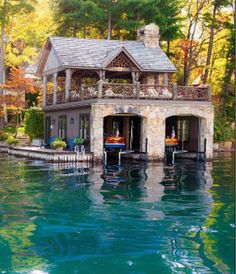 a house on the water surrounded by trees