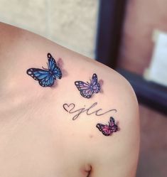 three butterflies with the word love tattooed on their shoulder