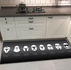 a kitchen area rug with star wars characters on it in front of a stove top