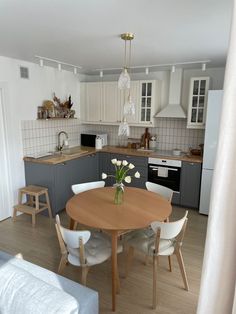 a kitchen with a table and chairs in it