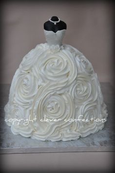 a wedding dress cake with white icing on it's bottom and black top