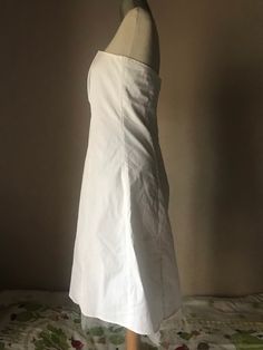 "How simple and beautiful is that! The totally white makes it divinely simple! Cotton strapless dress with some stretch fitted bust, fully lined with white satiny lining that ends to a tulle petticoat all around the finishing hem by creating a semi-full skirt from the mid '90s. Closes with a painted metal zipper up back. A bit fitted waistline, flared circle skirt that is enriched with a white tulle petticoat (You may also add one more petticoat if you have one and you want to give even more vol White Fitted A-line Strapless Dress, White Sleeveless Petticoat For Summer, Fitted Knee-length Summer Petticoat, White Knee-length Strapless Wedding Dress, White Fitted Strapless A-line Dress, Elegant White Petticoat With Fitted Bodice, White Strapless Stretch Mini Dress, White Sleeveless Petticoat For Spring, White Strapless Knee-length Summer Dress