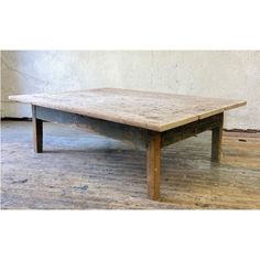 an old wooden table sitting on top of a hard wood floor