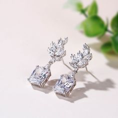 In all their formal elegance, these leaf design drop earrings are unsurpassed with magnificence and sparkle. Crafted in sterling silver, each earring features a radiant cut stone sparkling crazily on your ear, while glistening marquise cut stones complete the leaf design. A stylish anytime choice, these vintage earrings are a must-have for your jewelry box.Carat Weight: 4.5 ctStone Size: 2*4,3*6,2*3 mmStone Type: Jeulia® StoneNumber of Stones: 16 Stone Shape: MarquiseStone Color: Diamond WhiteWe Elegant Sparkling Cubic Zirconia Cluster Earrings, Exquisite Silver Cubic Zirconia Cluster Earrings, Elegant Diamond Cut Drop Crystal Earrings, Glamorous Diamond Cut Silver Earrings, Glamorous Silver Diamond Cut Earrings, Silver Baguette Cut Fine Jewelry Earrings, Silver Baguette Cut Cubic Zirconia Earrings, Elegant Baguette Cut Diamond Accented Earrings, Elegant Baguette Cut Diamond Accent Earrings