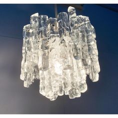 a chandelier made out of ice cubes hanging from a ceiling in a room