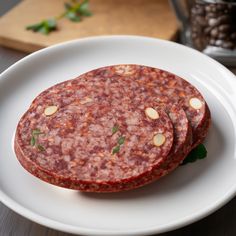 two sausage patties are on a white plate