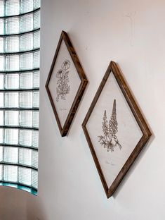 two framed pictures hanging on the wall next to each other