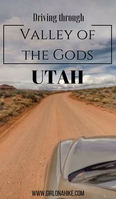 a car driving down a dirt road with the words driving through valley of the gods utah