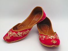 Ethnic Indian/Pakistani style shoes durable and hand stitched with genuine leather sole and leather padded cushion inside. these offer a lovely color of pink with gold design along the shoe. The pink velvet fabric embroidered with gold in zardozi work with gold sequence in a flower design with all around embroidery and perfect leather trimming to add to the style and comfort. They offer comfort and style, while still looking fabulous in these. Perfect or brides or everyday outfits. We offer many Bohemian Embroidered Closed Toe Flats, Embroidered Leather Flats With Flat Heel, Embroidered Leather Slip-on Flats, Leather Embroidered Flats, Summer Festive Slip-on Flats, Festive Summer Slip-on Flats, Traditional Embroidered Flats For Festivals, Handwork Flats For Festive Summer Occasions, Traditional Embroidered Flats For Diwali