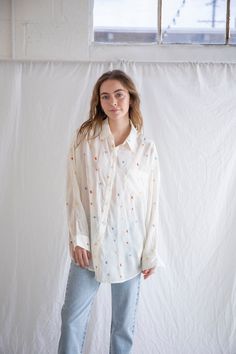 Breezy button-up with embroidered details. - Sizing: Model is 5'8", wearing a size S - Content: 100% Polyester Care: Handwash recommended Imported Floral Embroidered Shirt For Workwear In Fall, Floral Embroidery Button-up Work Tops, Casual Embroidered Blouse For Daywear, Relaxed Fit Blouse With Floral Embroidery For Day Out, Relaxed Fit Floral Embroidery Blouse For Day Out, Floral Embroidery Button-up Top For Work, Casual Embroidered Shirt For Daywear, Embroidered Relaxed Fit Shirt For Spring, Collared Shirt With Floral Embroidery For Daywear