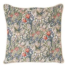 an embroidered pillow with flowers and leaves on the front in green, blue, red and white