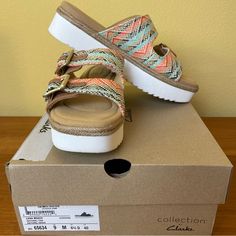 These Cute Platforms Feature Adjustable Double Buckles. Leather And Multicolor Woven Textile On The Upper. Insole Is Clean! White Sawtooth Soles For A Slip Resistant Stride. Memory Foam Footbed. They Look Brand New. 2” Heel We Are A Non Smoking Home. Tags: Beach, Sandals, Coastal, Wedge, Platform, Espadrille, Slip-Ons, Comfort, Ortholite Footbed, Casual, Boho, Bohemian, Festival Comfortable Blue Wedge Sandals For Beach, Multicolor Wedge Sandals With Cushioned Footbed And Round Toe, Multicolor Platform Sandals For Beach, Multicolor Slip-on Espadrilles For Beach, Orange Sandals With Woven Sole For The Beach, Orange Synthetic Wedge Sandals For Vacation, Summer Platform Orange Sandals, Orange Slip-on Wedge Sandals For Beach, Orange Slip-on Wedge Sandals For Summer