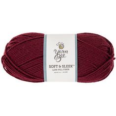 yarn ball in dark red color with white label on the top and bottom, for knitting or crocheting