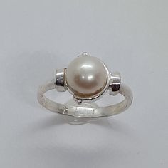 This handmade, beautiful Pearl ring has been expertly crafted in warm 925 sterling silver , authentic pearl . This gorgeous ring will make a great special occasion/ birthday gift. All of my jewelry is handmade from scratch, one item at a time as I like to make sure I am producing a high quality item. A tracking shipping number will be provided to you once the ring has been shipped. Pearl measurements:  White Pearl: 7.7 mm Ring size : 6 3/4 Ring Weight: 2.6 grams Ring Band at smallest point: 2.23 Classic Sterling Silver Pearl Drop Ring, Classic Pearl White Pearl Ring For Gift, Classic White Pearl Ring For Gifts, Sterling Silver Pearl Ring As Gift, White Sterling Silver Pearl Ring Gift, Hallmarked Sterling Silver Pearl Ring For Gift, Handmade Classic Pearl Ring As A Gift, Handmade Classic Pearl Ring As Gift, Handmade Classic Pearl Ring For Gift