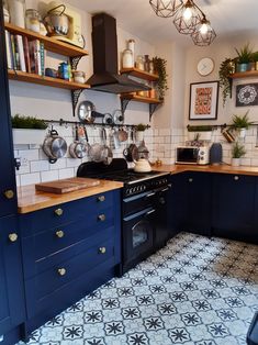 the kitchen is clean and ready for us to use it's blue cabinetry