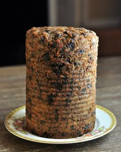 a close up of a cake on a plate on a table with a wooden surface