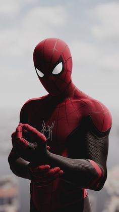 a man in a spider - man suit is holding his hands out to the side