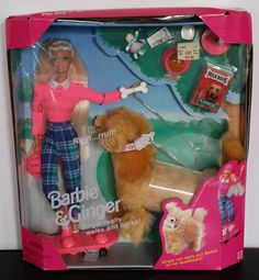 a barbie doll and her dog in a box