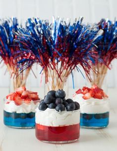 red, white and blue desserts in small glass jars