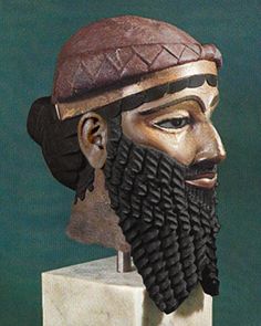 a statue of a man with a beard wearing a hat and braids on his head