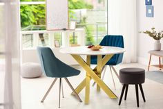 a white table with two blue chairs and a yellow plate on it