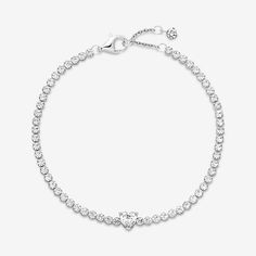 Bring elegance to your outfit with the Sparkling Pavé Tennis Bracelet. Hand-finished in sterling silver, this tennis bracelet is decorated with sparkling clear cubic zirconia. A large central heart-shaped stone punctuates a row of evenly sized pavé. The bracelet includes a lobster clasp for safe closure and can be adjusted to three lengths. Style it with other shimmering Pandora Timeless pieces for a classic look that stands out. - Pandora Sparkling Heart Tennis Bracelet - Sterling silver / Cubic Zirconia / Clear - Sz. 7.1 in Pandora Anklet, White Gold Heart Cut Tennis Bracelet, Heart Cut Cubic Zirconia Tennis Bracelet In White Gold, Cubic Zirconia Heart Cut Tennis Bracelet In White Gold, Pandora Tennis Bracelet, Classic Silver Diamond Heart Bracelet, Pandora Bracelet Tennis, Classic Silver Heart Bracelet With Cubic Zirconia, Classic Silver Cubic Zirconia Heart Bracelet