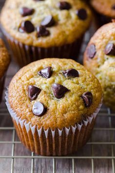 chocolate chip muffins on a cooling rack with other muffins in the background