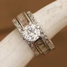 a close up of a ring on top of a white marble object with diamonds in it