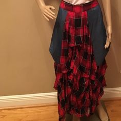 a mannequin wearing a red and black plaid skirt with ruffles on the bottom