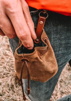 a person holding a small brown bag in their hand