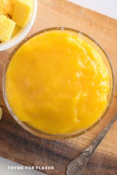 a bowl of mango custard on a cutting board