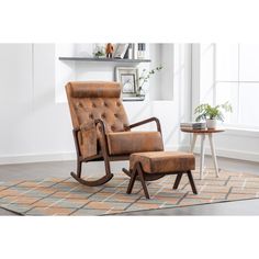 a brown leather rocking chair and ottoman in a living room