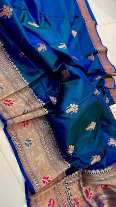 Grace and Beauty combined in this timeless Bridal Banarasi Saree in Peacock blue colour comes in a dual tone shade of extreme beauty.... Deams are woven in antique gold zari with Minakari weaving, making it a symphony of elegance as well as tradition. Handwoven Pure katan silk Banarasi Saree from the land of Banarasi sarees, Varanasi,a land of culture, tradition and spiritual ambience. Crafted with intricate patterns of traditional kudwa weaving. Make it yours for your special day or be special for any occasion like Weeding,bridal ceremony,party,festive mood ,be stand out in style with a classic master piece of traditional elegance Saree comes with Silk Mark Certification that ensures authenticity and quality, making them a reliable choice for those who are seeking genuine Silk Products. E Blue Silk Dupatta For Festivals, Blue Raw Silk Dupatta With Pallu, Festive Blue Tussar Silk Traditional Wear, Blue Silk Traditional Wear For Festivals, Traditional Blue Raw Silk Saree, Blue Raw Silk Saree With Dupatta, Traditional Blue Tussar Silk Dupatta, Festive Blue Katan Silk Dupatta, Diwali Blue Tussar Silk Dupatta