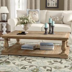 a living room with white couches and a coffee table