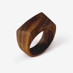 The Twist ring handmade from solid black walnut wood. Made to your ring size when you order, other woods available upon request. A classic design with a surrealist twist. We take the ring's rectangular face and shape it by hand into a melting, twisting, fluid design. The diagonally stretched design is emphasized by using select grain patterns and wood, while the robust body of the ring balances the liquid surrealism of the design. For this offering we chose the rich, dark chocolatey goodness of walnut wood. We use an all-natural, environmentally friendly, biodegradable oil finish that is scratch and water-resistant. What you see pictured are pieces I have made and represent what you are ordering. However, your ring will be unique to you and may vary slightly in color and grain pattern. Woo Rectangular Face, Fluid Design, Black Walnut Wood, Nature Ring, Jewelry Minimalist, Detailed Ring, Twist Ring, Wood Rings, Unisex Ring