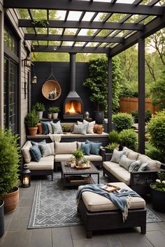 an outdoor living area with couches, tables and potted plants