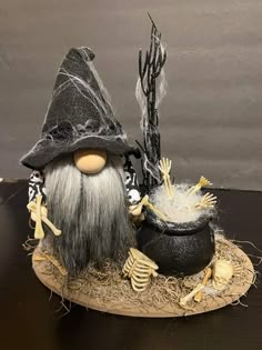 an image of a halloween scene with a wizard hat and caulder on the table