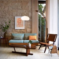 a living room filled with furniture next to a window