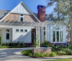 a white house with a red brick chimney