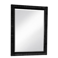 a black framed mirror sitting on top of a white wall